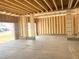 Spacious new construction garage featuring wooden framing and a smooth concrete slab at 139 Fast Pitch Ln, Four Oaks, NC 27524