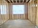 A view of the interior framing, in the new home construction with concrete flooring at 139 Fast Pitch Ln, Four Oaks, NC 27524