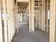 Interior view of the new home construction, highlighting wooden framing and concrete flooring at 139 Fast Pitch Ln, Four Oaks, NC 27524