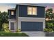 Charming two-story home featuring blue vertical siding, horizontal siding, and an attached two-car garage at 140 Lillian Ct, Roxboro, NC 27573