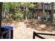 Backyard view showing mature trees, a deck, storage containers and is perfect for quiet outdoor living at 1505 Kendall Dr, Durham, NC 27703