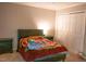 Bedroom showcasing a bed with a vibrant blanket, neutral walls, carpeting, and built in closet space at 1505 Kendall Dr, Durham, NC 27703