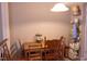 A dining room with a wooden table, four chairs, and a neutral-colored wall at 1505 Kendall Dr, Durham, NC 27703