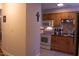 A spacious kitchen with wooden cabinets, white appliances, and decorative tile backsplash at 1505 Kendall Dr, Durham, NC 27703