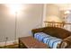 A cozy living room with a brown sofa, a wooden table, and a floor lamp at 1505 Kendall Dr, Durham, NC 27703
