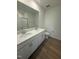 Modern bathroom featuring double sinks, quartz counters, and a glass shower at 168 Parker Ln, Mebane, NC 27302