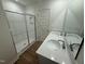 Contemporary bathroom with double sinks, a quartz countertop, and a glass-enclosed shower at 168 Parker Ln, Mebane, NC 27302