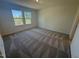 Cozy bedroom with two bright windows and soft carpet at 168 Parker Ln, Mebane, NC 27302