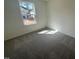 A bedroom with carpet flooring is brightened by natural light from a window at 168 Parker Ln, Mebane, NC 27302