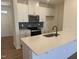 Bright kitchen featuring white cabinets, a quartz island, and stainless steel appliances at 168 Parker Ln, Mebane, NC 27302