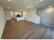 Open-concept kitchen and living room with hardwood floors and staircase in the background at 168 Parker Ln, Mebane, NC 27302