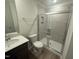 Modern bathroom with a tiled shower, glass door, a white toilet and dark vanity with sink at 172 Parker Ln, Mebane, NC 27302