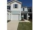 Charming two-story townhome with a white garage door, blue siding and a well-maintained front yard at 172 Parker Ln, Mebane, NC 27302