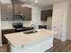 Modern kitchen with stainless steel appliances, dark cabinets and white countertops with a center island sink at 172 Parker Ln, Mebane, NC 27302