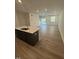 Open-concept kitchen, living and dining room, with light-colored wood floors and recessed lighting at 172 Parker Ln, Mebane, NC 27302