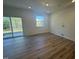 Bright, open living room features wood floors, large windows and glass sliding doors leading to the backyard at 172 Parker Ln, Mebane, NC 27302