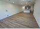 Spacious living area with wood floors, recessed lighting and an open floorplan that connects to the kitchen at 172 Parker Ln, Mebane, NC 27302