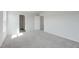 Carpeted bedroom featuring doorways to two other rooms and neutral, white walls at 176 Lillian Ct, Roxboro, NC 27573