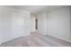 Bright bedroom features neutral carpet, white walls, white trim, and a closet at 176 Lillian Ct, Roxboro, NC 27573