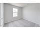 Bright, carpeted bedroom with a window offering natural light at 176 Lillian Ct, Roxboro, NC 27573