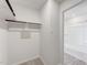 Walk in closet features wooden hanging bar, electrical outlets and entry to bathroom at 176 Lillian Ct, Roxboro, NC 27573