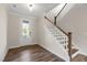 Inviting entryway features wood-look floors and a staircase with wood and white railing at 1809 Harrell Cove Ct Ct # 181 Gunnison Fc, Fuquay Varina, NC 27526