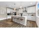 Modern kitchen boasts a spacious island with bar stools, stainless steel appliances, and ample counter space at 1809 Harrell Cove Ct Ct # 181 Gunnison Fc, Fuquay Varina, NC 27526