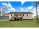 Home exterior shows spacious backyard with lush lawn and a wooden deck at 203 Sourgum Ct, Zebulon, NC 27597