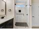 Bathroom featuring a tiled shower with glass enclosure, a transom window, and modern black fixtures at 203 Sourgum Ct, Zebulon, NC 27597