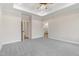 Large bedroom with neutral walls, ceiling fan, and access to an ensuite bathroom at 203 Sourgum Ct, Zebulon, NC 27597