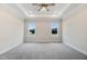 Spacious bedroom with plush carpet, tray ceiling, and an abundance of natural light at 203 Sourgum Ct, Zebulon, NC 27597