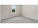 An empty bedroom with neutral walls and carpet offers a blank canvas for personalization and comfort at 203 Sourgum Ct, Zebulon, NC 27597