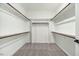 Bright walk-in closet features wooden rods, white shelving, and plush gray carpeting at 203 Sourgum Ct, Zebulon, NC 27597
