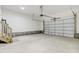 Spacious two-car garage with stairs and concrete flooring is ready for your cars and storage at 203 Sourgum Ct, Zebulon, NC 27597