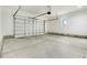 Spacious two-car garage with concrete floor, side window, and large metal garage door at 203 Sourgum Ct, Zebulon, NC 27597