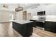 Well-lit kitchen boasts stainless steel appliances, a spacious island, and a stylish light fixture at 203 Sourgum Ct, Zebulon, NC 27597