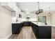 Contemporary kitchen features a central island, contrasting cabinetry, and an open design at 203 Sourgum Ct, Zebulon, NC 27597