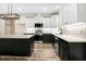 Modern kitchen featuring a center island, white cabinetry, and sleek stainless steel appliances at 203 Sourgum Ct, Zebulon, NC 27597