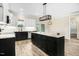 Open kitchen layout with a large island, stainless steel appliances, and easy access to outdoor spaces at 203 Sourgum Ct, Zebulon, NC 27597