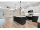 Open-concept kitchen featuring a center island, stainless steel appliances, and modern finishes at 203 Sourgum Ct, Zebulon, NC 27597