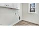 A laundry room features white cabinets and a window at 203 Sourgum Ct, Zebulon, NC 27597