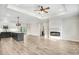 Open concept living area connects a modern kitchen with a cozy electric fireplace at 203 Sourgum Ct, Zebulon, NC 27597