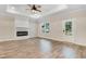 Spacious living room featuring wood floors, a modern fireplace, recessed lighting, and a ceiling fan at 203 Sourgum Ct, Zebulon, NC 27597
