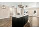 Spacious living area with an island, fireplace, and large windows for plenty of natural light at 203 Sourgum Ct, Zebulon, NC 27597