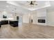 Bright open-concept living space with modern fireplace, sleek island, and ample natural light at 203 Sourgum Ct, Zebulon, NC 27597