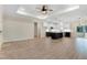 Open-concept living room featuring wood floors and a view into the modern kitchen with an island and stainless appliances at 203 Sourgum Ct, Zebulon, NC 27597