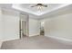 Spacious bedroom boasts a tray ceiling, neutral carpet, and easy access to the en-suite bathroom at 203 Sourgum Ct, Zebulon, NC 27597