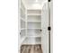 Pantry features white shelving, wooden floor, and open door at 203 Sourgum Ct, Zebulon, NC 27597