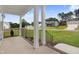 View from a covered porch with white columns, black railings, and a neighborhood view at 203 Sourgum Ct, Zebulon, NC 27597