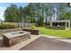 Backyard featuring a stone fire pit, a wooden fence and a barbecue building with a screened-in area at 218 Darecrest Ln, Wendell, NC 27591